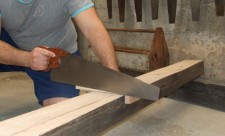 cutting wood with a saw costa rica